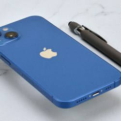 Blue Apple iPhone 14 on a marble table
