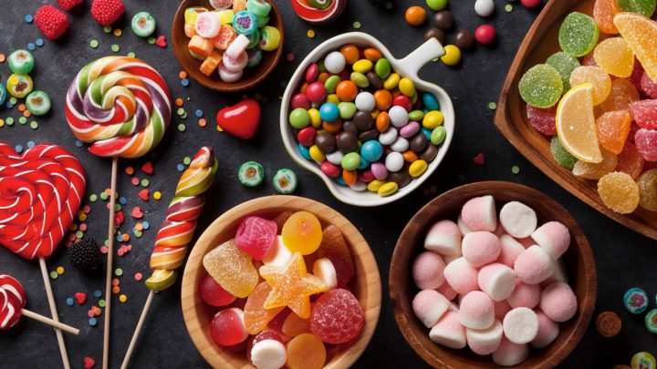 Colorful candies, jelly and marmalade on stone background