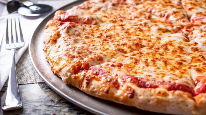 A closeup view of a plain cheese pizza pie.