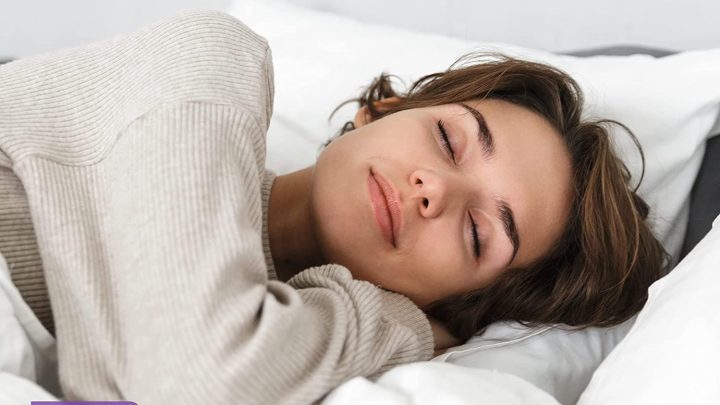 A woman sleeping comfortably in bed