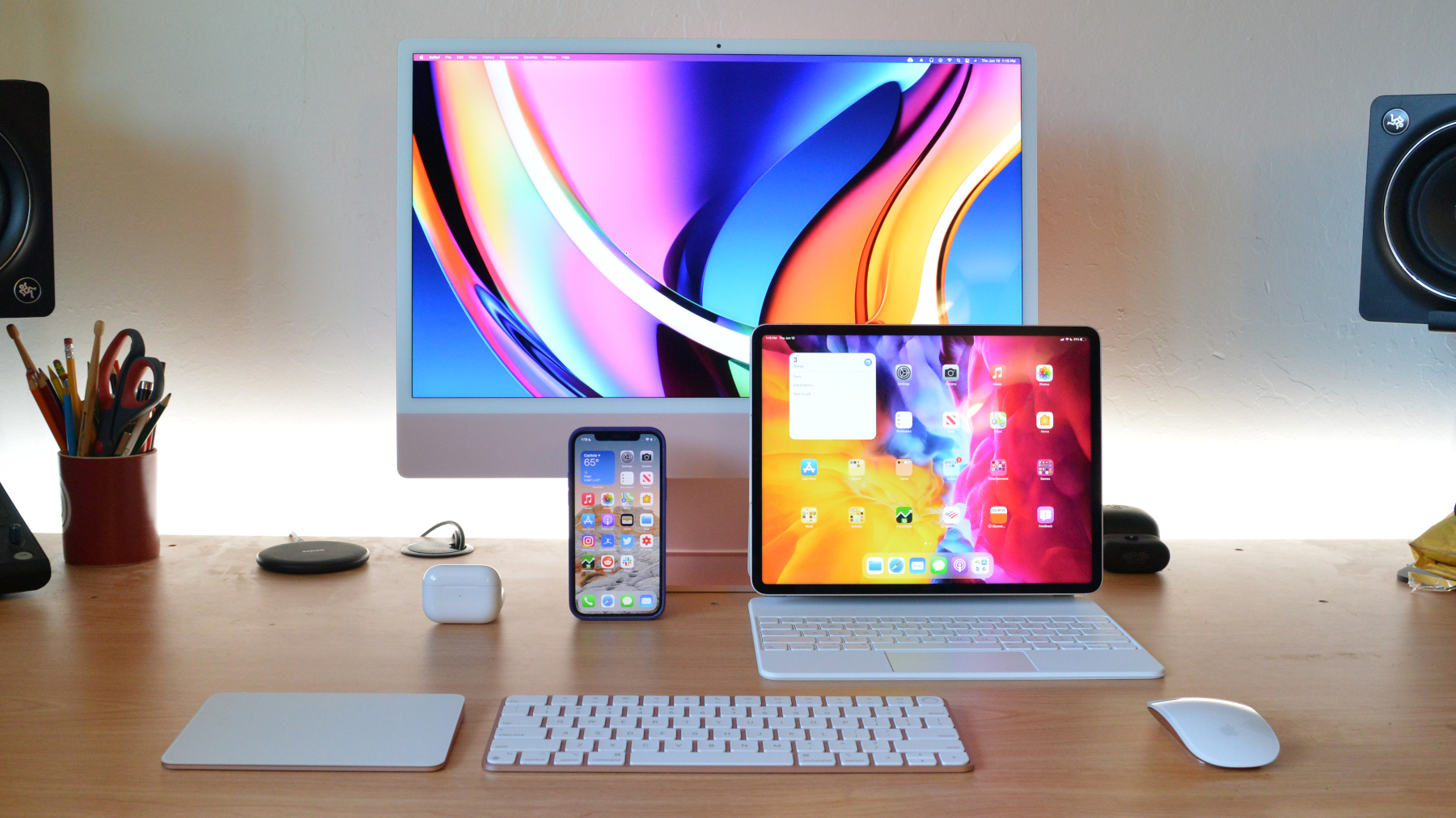 An iMac, iPad, iPhone, AirPods, and AirPods Pro