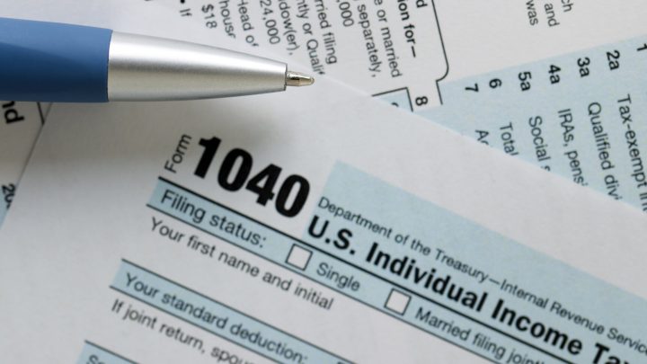 IRS 1040 tax form with pen