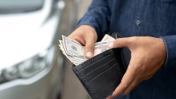 Man holding wallet with cash