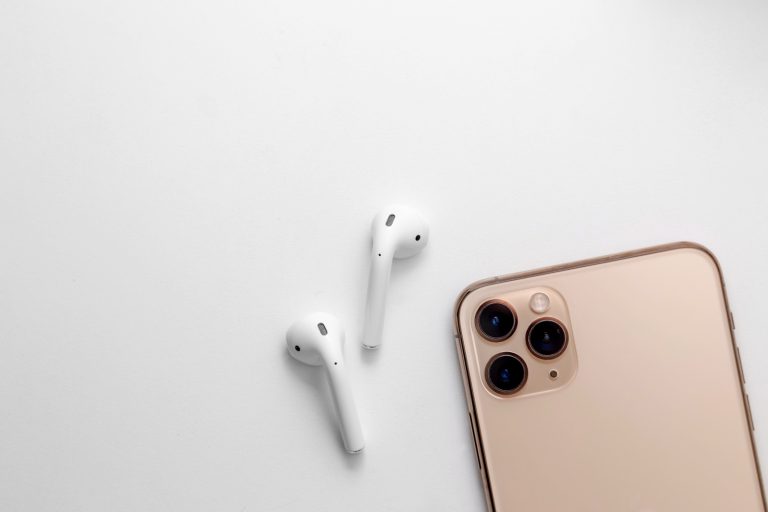 AirPods next to an iPhone model.