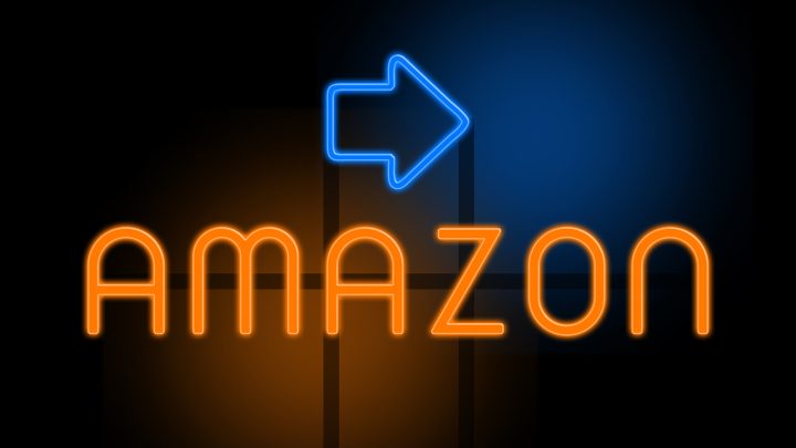 Amazon in orange glowing text with an arrow on dark background