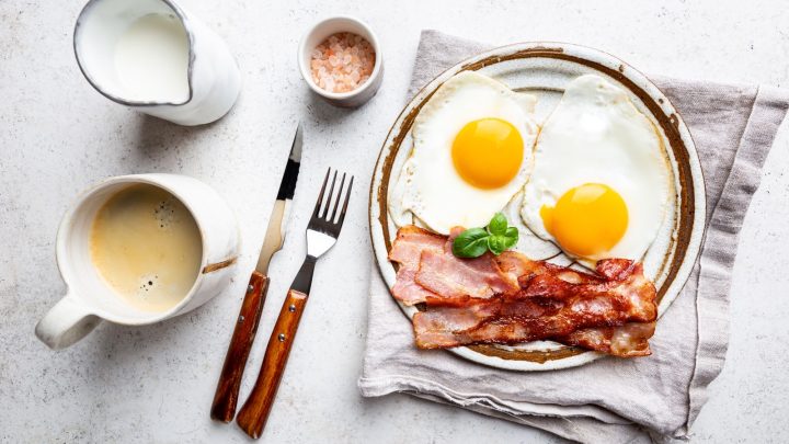 Fried eggs and bacon for breakfast on a plate.
