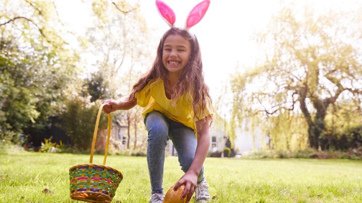 A girl on an Easter egg hunt in a garden