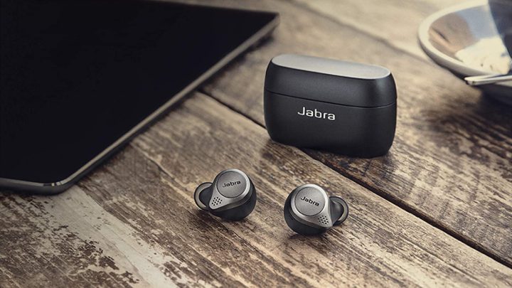 The Jabra Elite 75t Earbuds on a table next to an iPad tablet