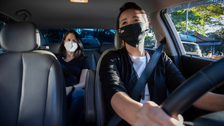 Uber rider and driver wearing masks.